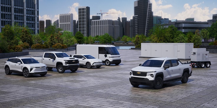 A fleet of various GM Envolve vehicles parked  on a job site.