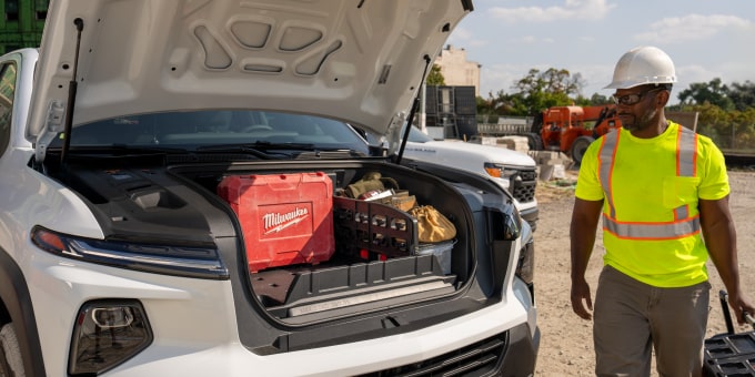 The open hood of the Silverado EV showing it's storage capacity filled with tools and equipment  