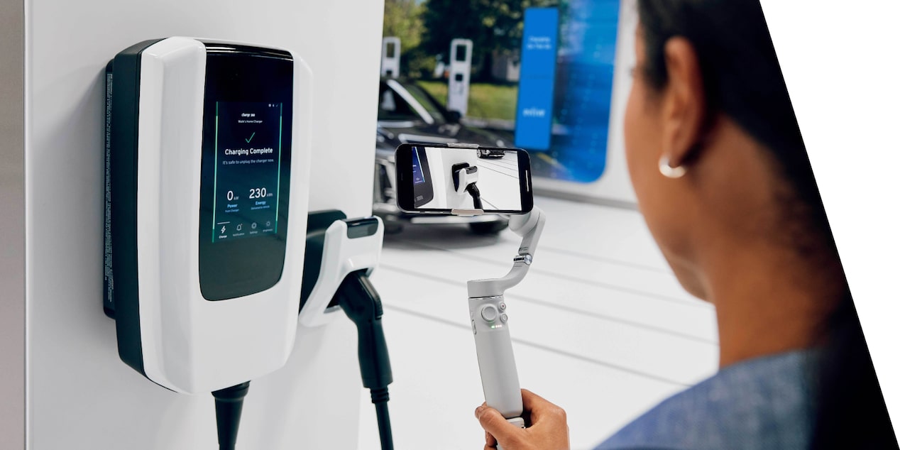 A Woman Using an Electric Vehicle Charging Station