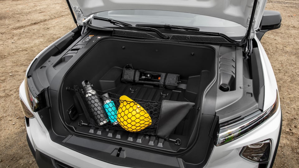 A closeup shot looking down at the trunk of the Summit White 2024 Chevrolet EV.