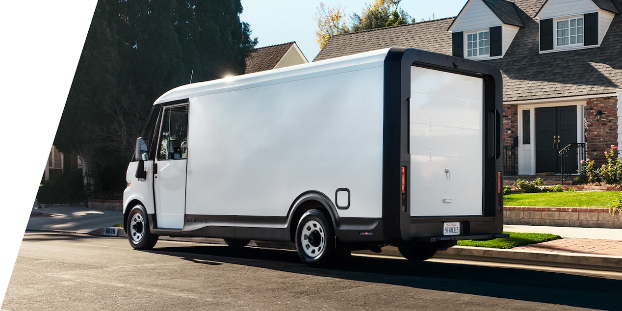 A 2025 BrightDrop parked in front of a house seen from the back in 3/4 view.
