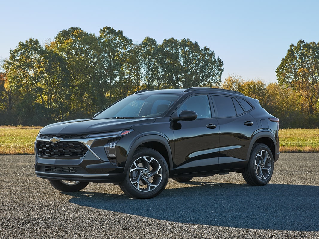 A 2026 Chevrolet Trax parked in three-quarter view in front of a field