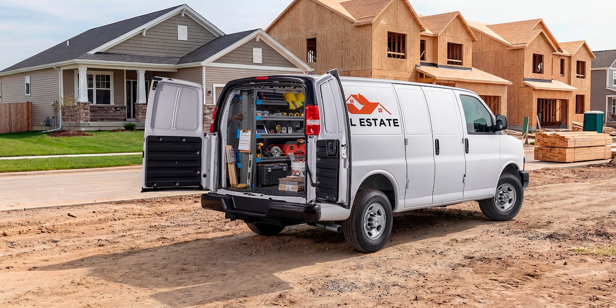 A white Chevrolet Express Cargo Van customized for construction