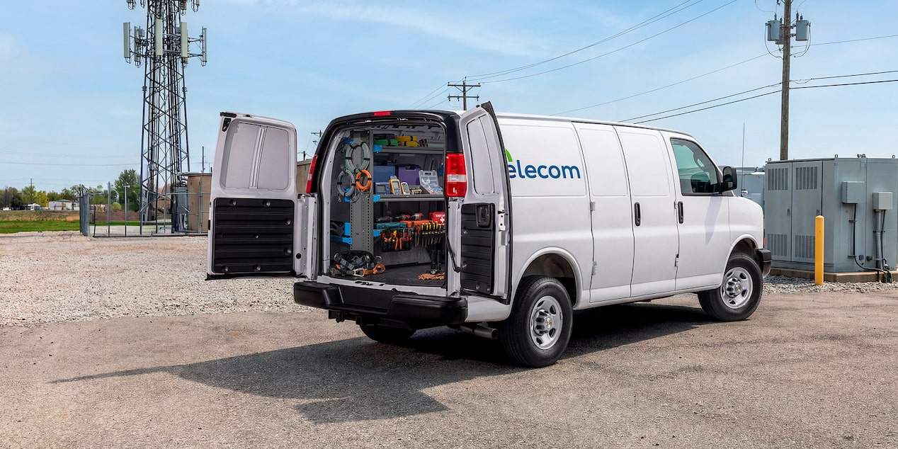 A white Chevrolet Express Cargo Van customized for telecom