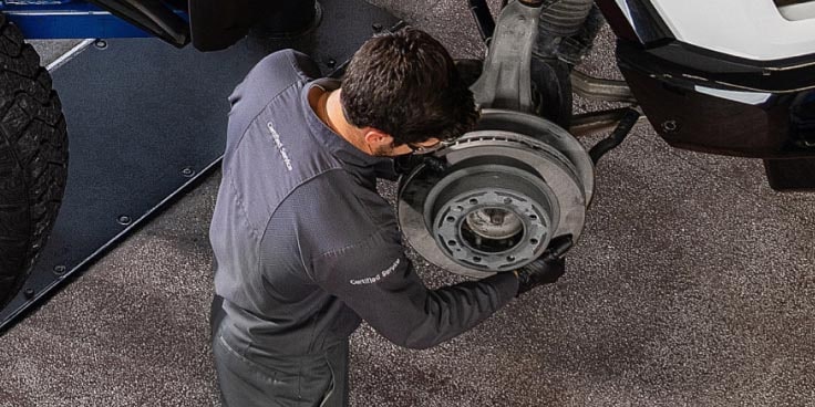 A mechanic servicing a vehicle