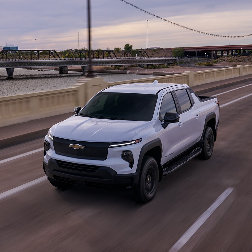 A Sliverado EV driving down a highway