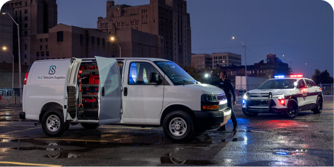 A Chevrolet Express van with Drive Block engaged as a police officer investigates