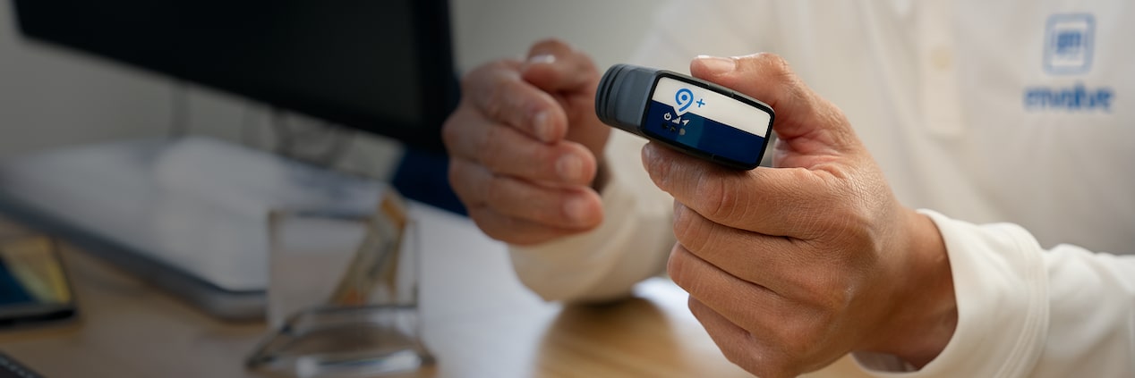 A close up of someone holding an OnStar Fleet Adapter