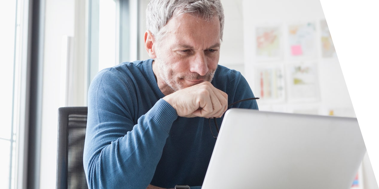 Man looking down at computer