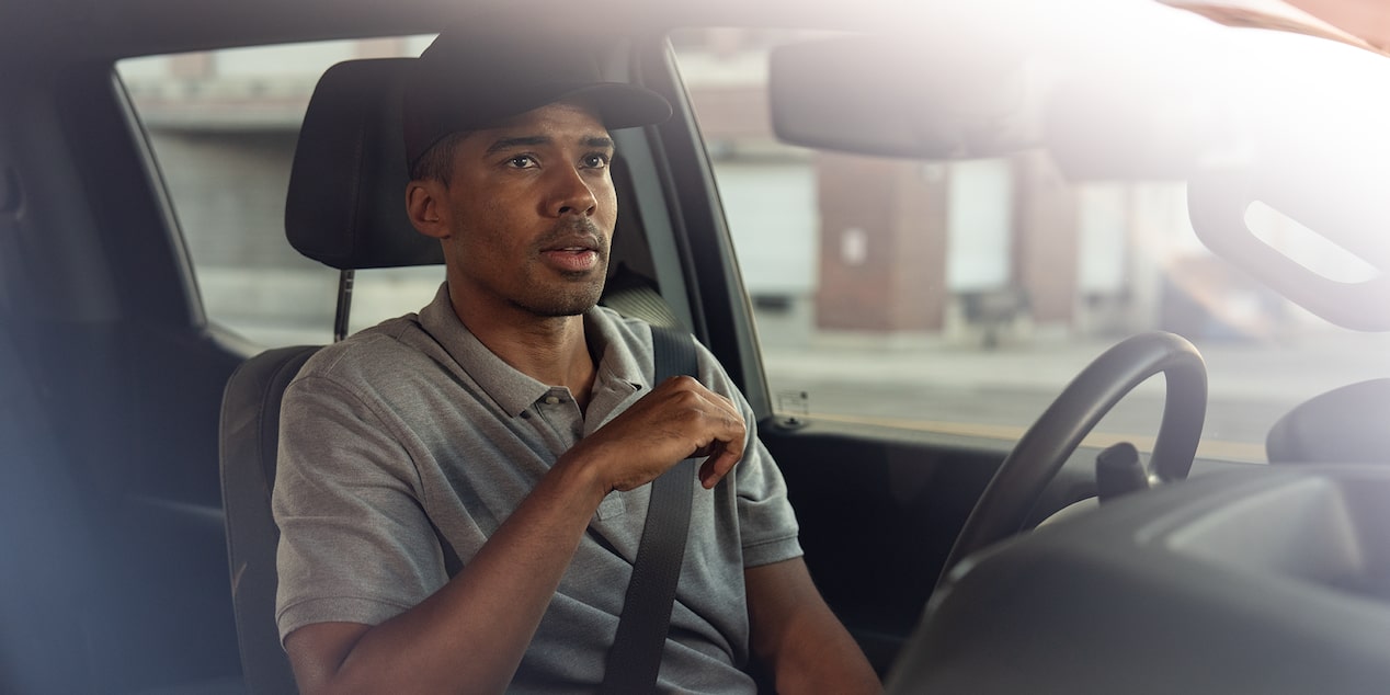 A construction worker sits in the driver seat of their Chevrolet Silverado.