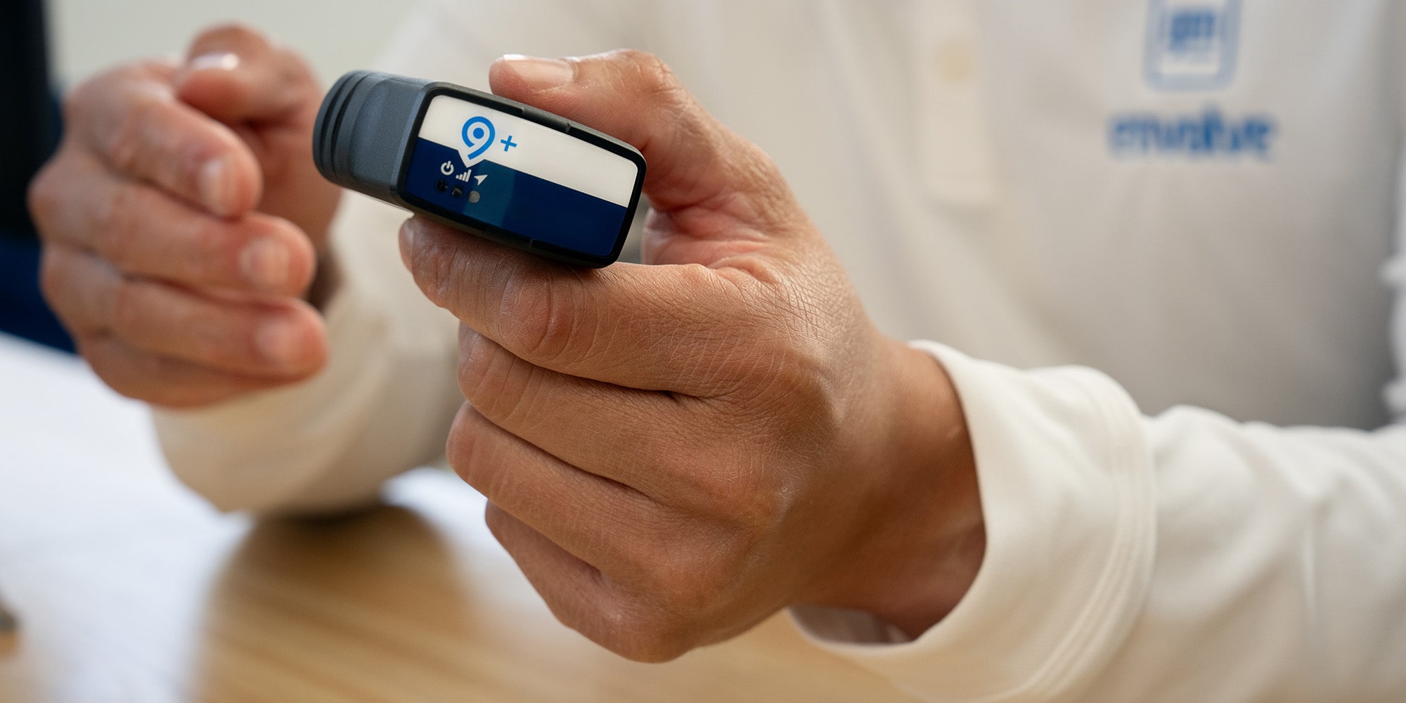 An OnStar fleet adapter being held by a GM Envolve employee.