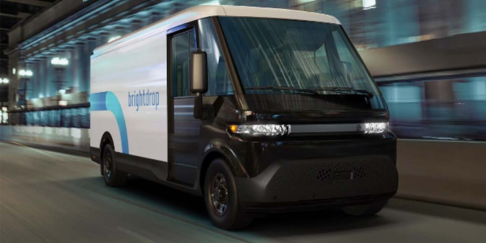 A BrightDrop Zevo EV Delivery Van Driving Down a City Street