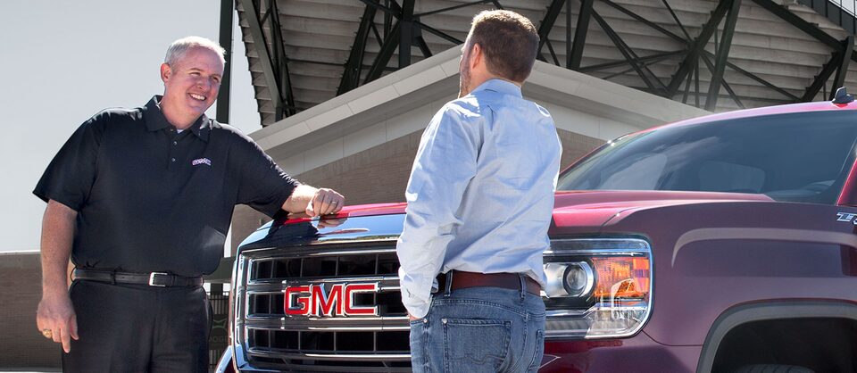 GMC Salesman Assisting Customer