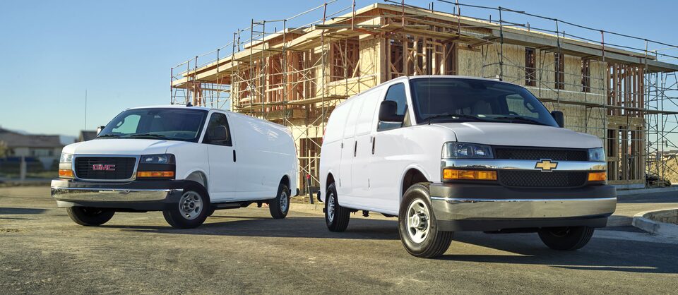 GMC Savana and Chevrolet Express Vans Side by Side on Worksite