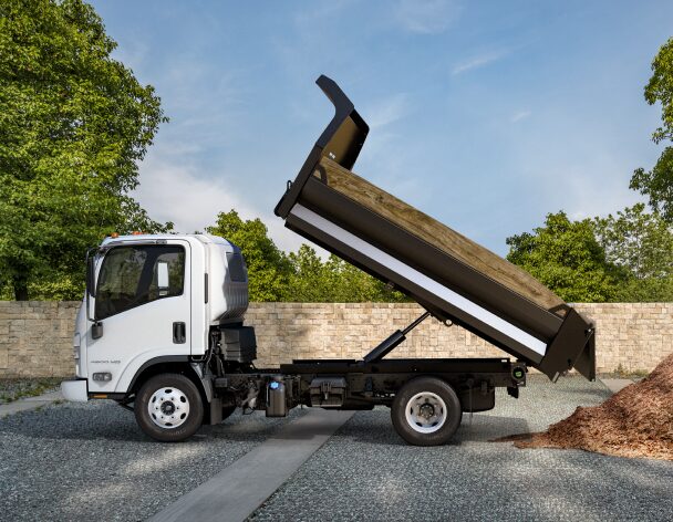 Side View of Chevrolet Low Cab Forward Truck Dumping Dirt Into a Pile