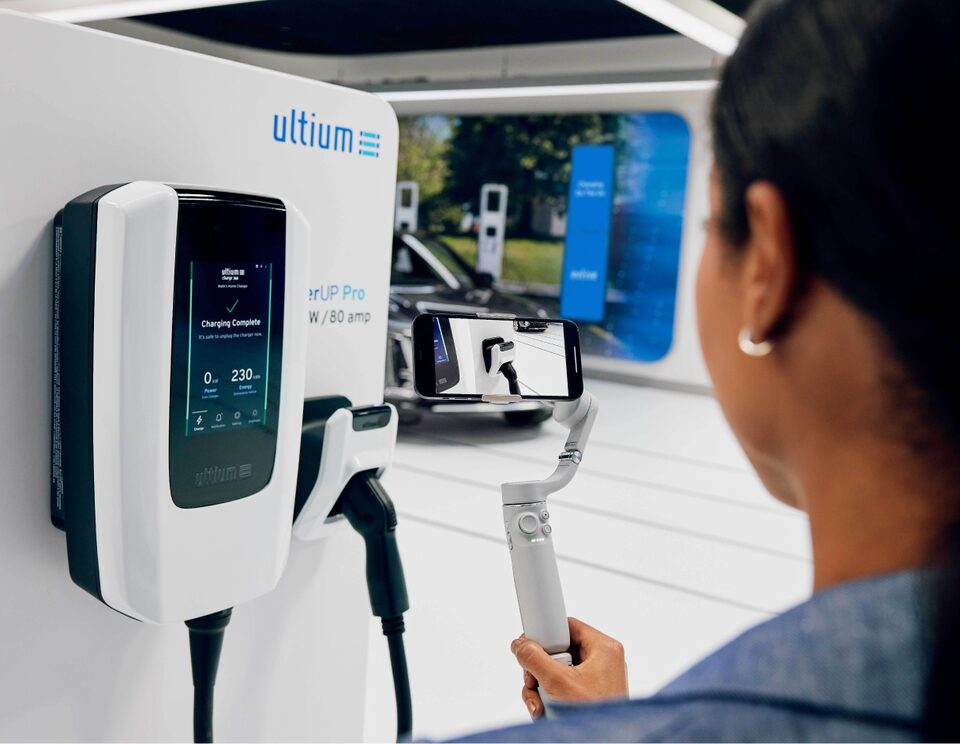 A Woman Using Ultium EV Charging Accessories