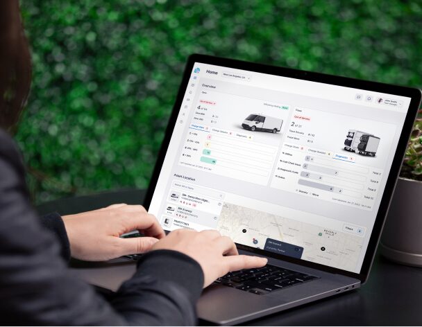 Person typing on laptop with BrightDrop products Displayed