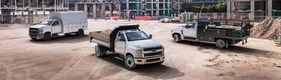 A Cargo Work Van, Brightdrop Vehicle and Heavy Duty Work Truck Side by Side