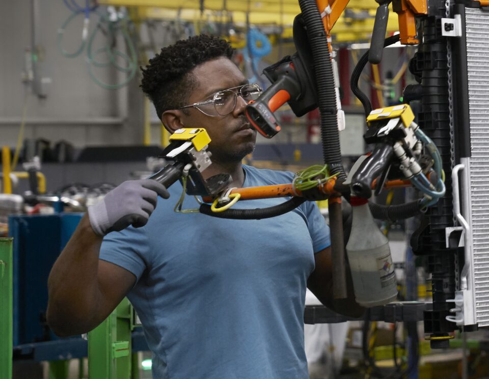 a Person working on the GM Assembly Line