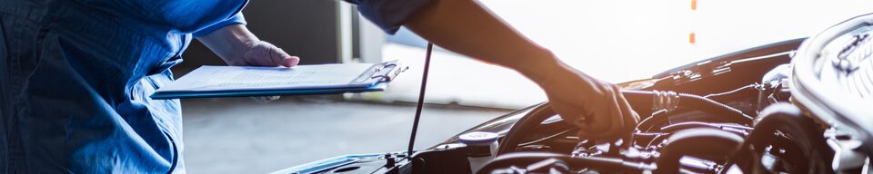 Close up view: GM Fleet Service Technician Inspecting Vehicle Engine