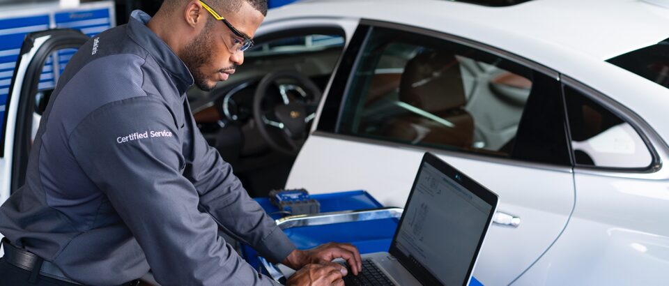 Man completing diagnostics on vehicle